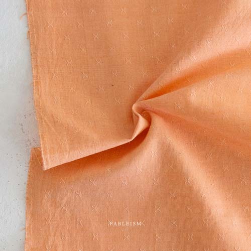Sprout Woven - Marmalade - light orange- texture w/a small woven "x"