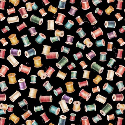 In Stitches - Bobbins - Black spools of colorful thread tossed on black